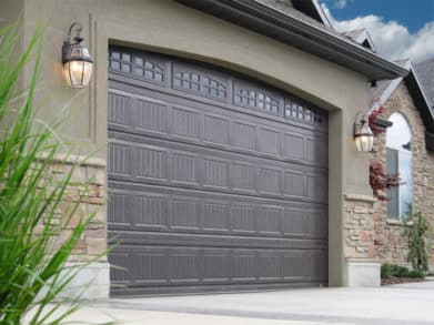 Dark brown modern garage door with small windows at the top