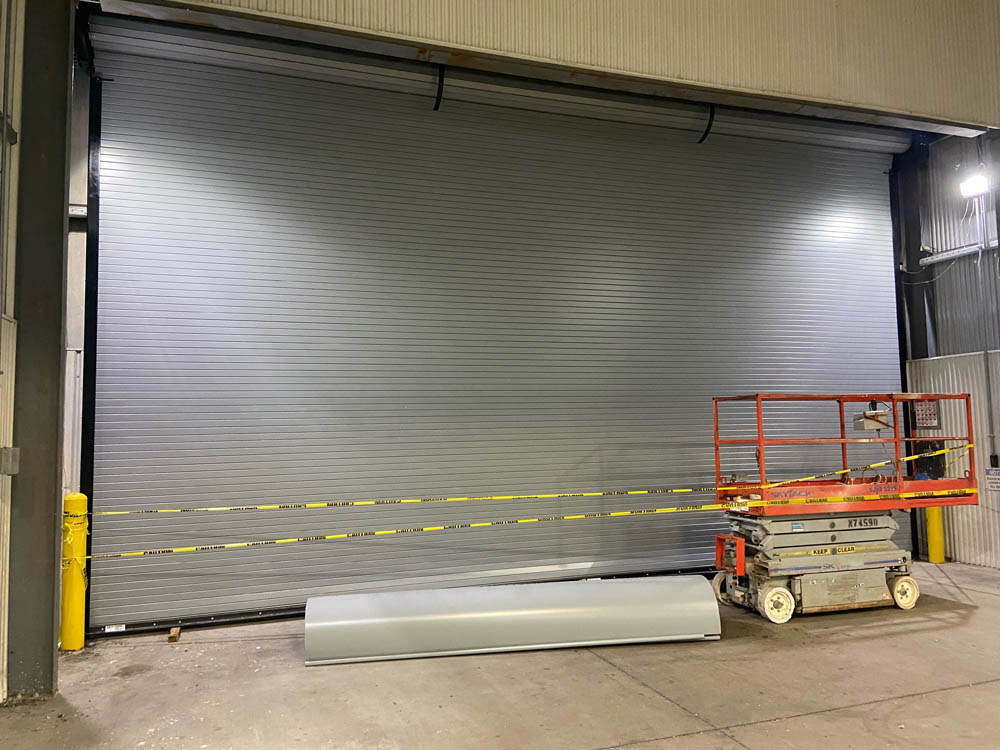 Image of Modern Grey Commercial Rolling Steel Garage Doors by Rose Quality Garage Doors Serving Murfreesboro, Nashville, Knoxville, Clarksville, and Franklin, TN locations.